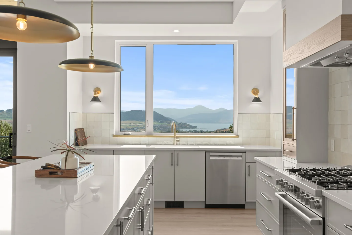 Kitchen window framing lake views beside the gas range